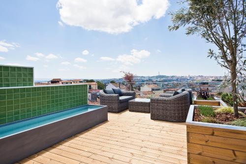 a roof deck with furniture and a view of the city at Acta The Avenue in Porto