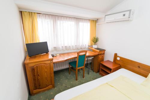 a room with a desk with a computer and a chair at Hotel Prebold in Prebold
