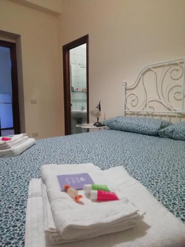 a bedroom with two towels and a book on a bed at B&B Murgantia in Morcone