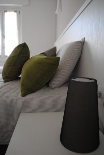 four pillows sitting on a bed with a window at DolceLago in Sirone