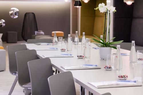 a long white table with chairs and vases on it at Best Western Plus Hotel Du Parc Chantilly in Chantilly