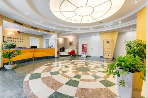 an office lobby with a large ceiling at Best Western Hotel Imperiale in Nova Siri Marina