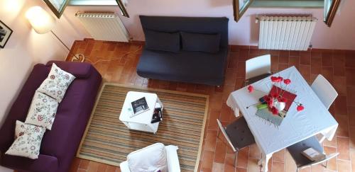 einen Blick über ein Wohnzimmer mit einem lila Sofa in der Unterkunft House in Montegridolfo in Montegridolfo