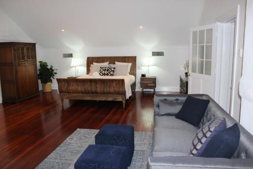 a living room with a bed and a couch at Fairlawn Estate in Busselton