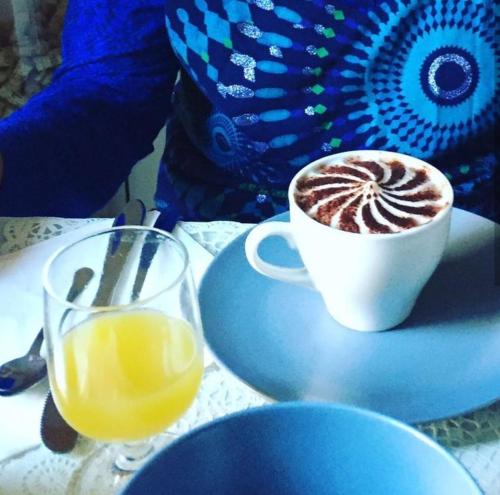 a cup of coffee and a glass of orange juice at Merulana Suite 2 in Rome