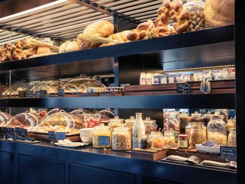a bakery with shelves filled with different types of bread at Mercure Budapest Korona in Budapest