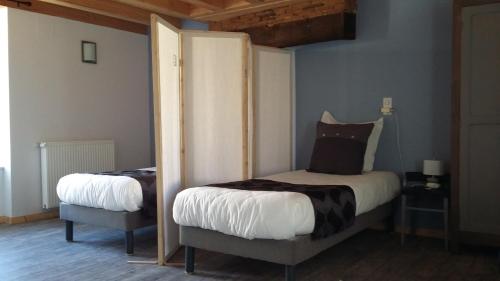 a bedroom with two beds in a room at LES GALAINES in Abzac
