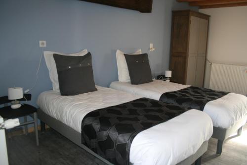 two beds sitting next to each other in a room at LES GALAINES in Abzac
