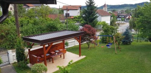 a gazebo with a bench and a swing at Apartmani Hršak in Krapina