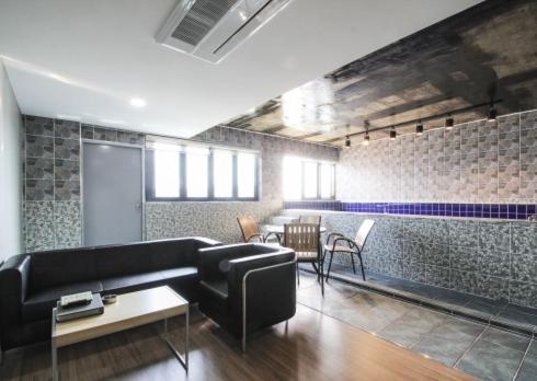 a living room with a couch and a table at No.1 New Yorker Hotel in Jinju