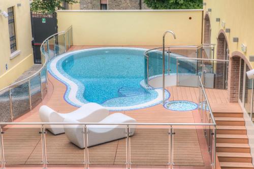 a swimming pool on the deck of a house at Hotel Il Duca Del Montefeltro in Pennabilli