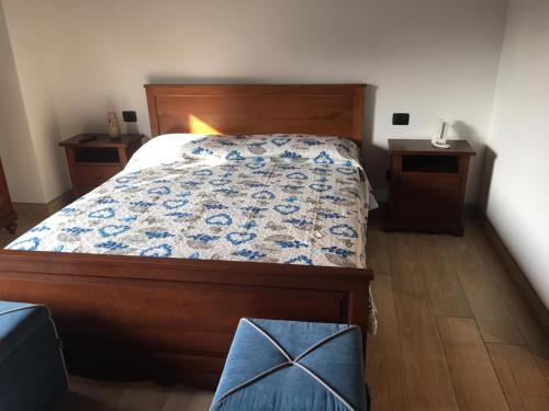 a bedroom with a bed and two night stands at B & B Lmc LA MADONNINA CHALET in Casteggio