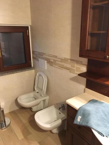 a small bathroom with a toilet and a sink at B & B Lmc LA MADONNINA CHALET in Casteggio