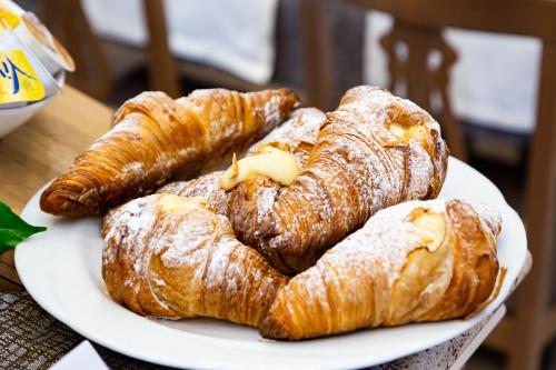 three croissants on a white plate on a table at Best Western Hotel Imperiale in Nova Siri Marina