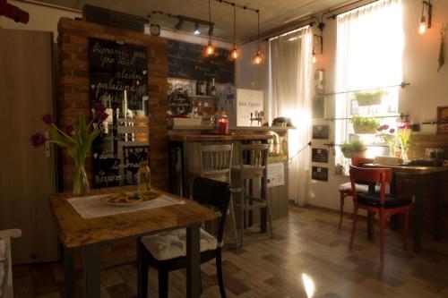 a dining room with a table and a bar at Apartmány u Bašty in Hlučín