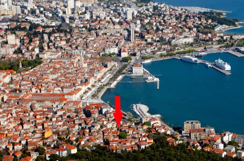 an aerial view of a city with a red arrow at Spartion Marine in Split