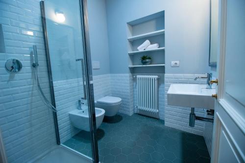 a bathroom with a toilet and a sink and a shower at Locanda Capolago in Colico