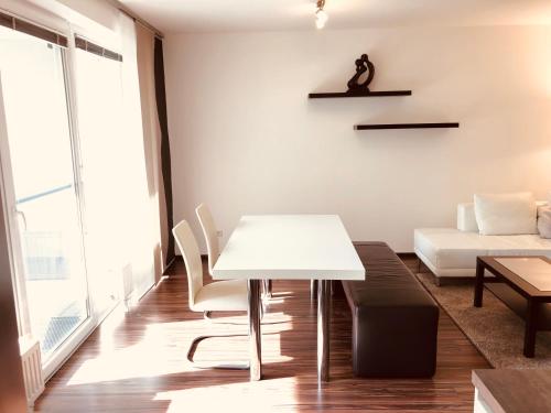 a living room with a white table and a couch at 25h GARDEN Apartment PLUS private Beach in Neusiedl am See