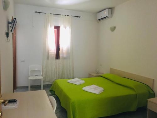 Ένα ή περισσότερα κρεβάτια σε δωμάτιο στο Albergo Villamarina