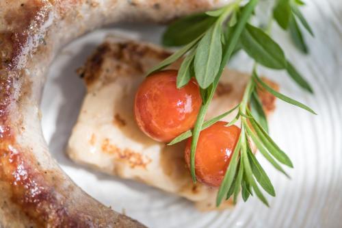 two tomatoes sitting on top of a white plate at Hostal Buenos Aires in Tremp