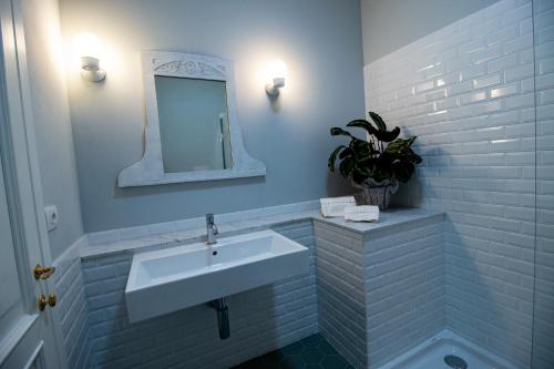 a bathroom with a white sink and a mirror at Locanda Capolago in Colico