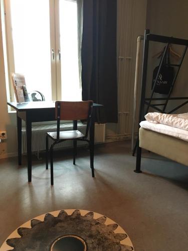 a room with a desk and a chair and a table at Norrqvarn Hotel & Resort by Vänerport in Lyrestad