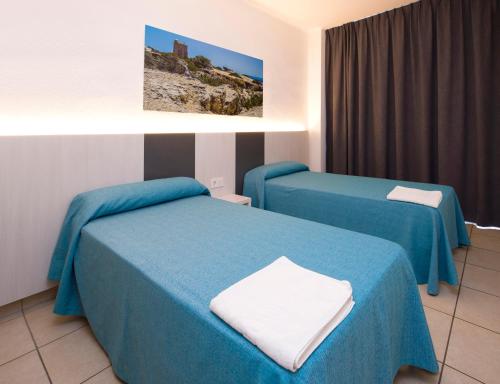 Ένα ή περισσότερα κρεβάτια σε δωμάτιο στο Apartamentos Tramuntana