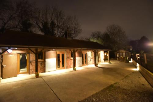 a building lit up at night with lights at Oak tree stables cottage in Birmingham
