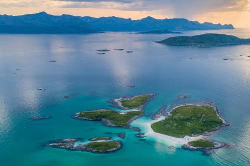 an island in the middle of a body of water at Sommarøy Arctic Hotel Tromsø in Sommarøy