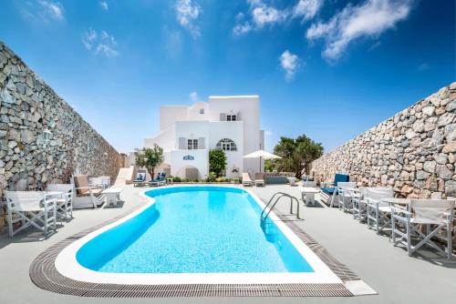 a swimming pool in front of a villa at LavaRock Santorini in Perissa