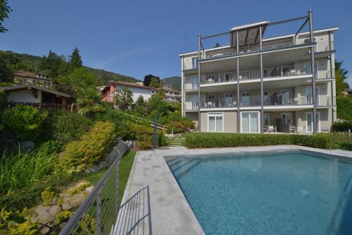 a house with a swimming pool next to a building at The View in Baveno