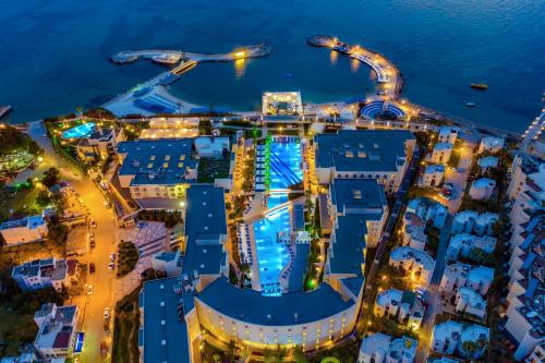 an aerial view of a cruise ship at night at La Blanche Resort & Spa in Turgutreis