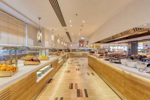 a large cafeteria with a buffet line of food at La Blanche Resort & Spa in Turgutreis