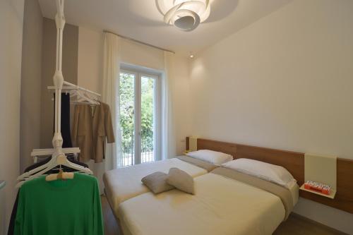 a bedroom with a large bed and a window at The View in Baveno