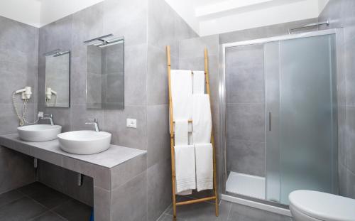 a bathroom with two sinks and a shower at Svevo Sea House in Vieste