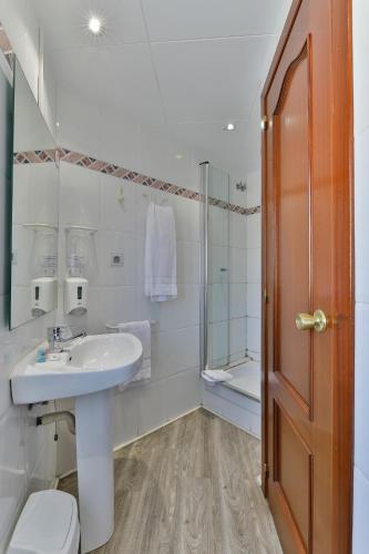 a bathroom with a sink and a toilet and a shower at Hostal Soler in Sant Joan de Vilatorrada