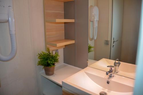 a bathroom with a sink and a mirror at Parc de vacances La Draille in Souillac