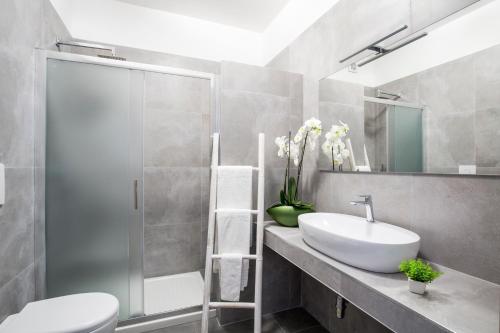 a bathroom with a sink and a shower and a toilet at Svevo Sea House in Vieste