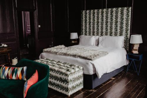 a bedroom with a large bed and a chair at Bellinter House Hotel & Spa in Navan