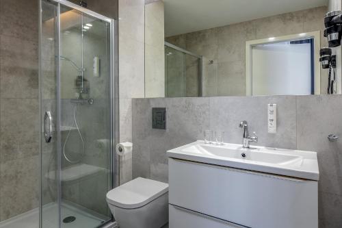 a bathroom with a toilet and a sink and a shower at Korona Hotel Wroclaw Market Square in Wrocław