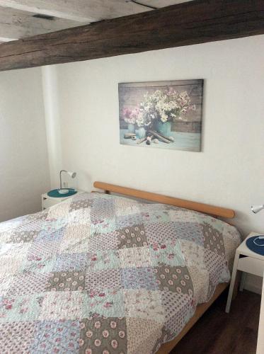 a bedroom with a bed with a quilt on it at Gästewohnung A+C Bovet in Strasen