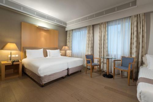 מיטה או מיטות בחדר ב-Central Hotel