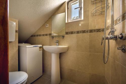 a small bathroom with a sink and a toilet at Boka Apartments in Tivat