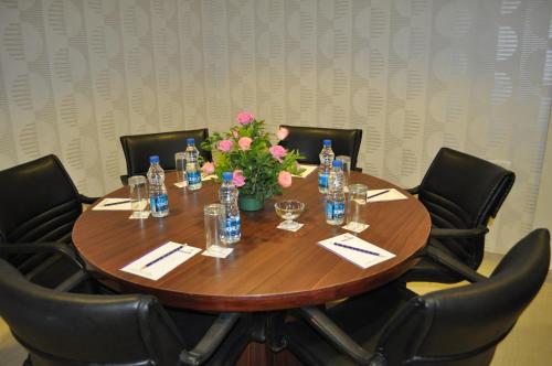 a table with a bunch of bottles and flowers on it at The Queeny in Vasco Da Gama