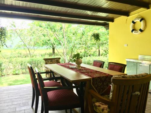a dining room with a wooden table and chairs at Yosemite Homestay in Yuanshan