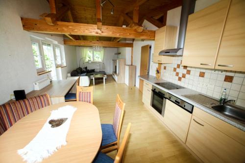 a kitchen and dining room with a table and chairs at Haus Alpengluehn in Iselsberg