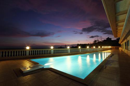a swimming pool at night on a building at The Queeny in Vasco Da Gama