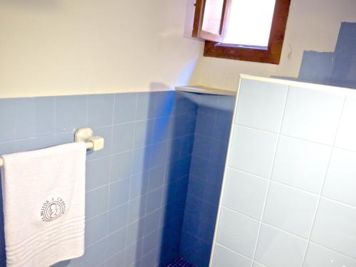 a blue tiled bathroom with a towel hanging on the wall at Olmitos 3, Casa-Palacio Real Piedad in Cehegín