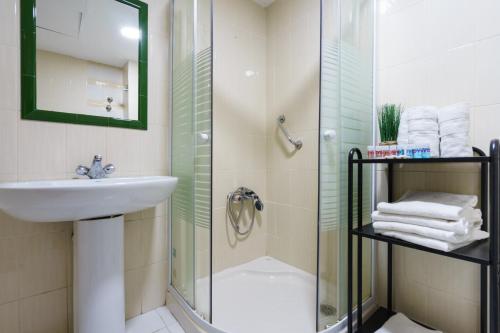 
a bathroom with a shower, sink, and toilet at Hotel Costa Andaluza in Motril
