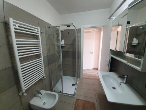 a bathroom with a sink and a shower and a toilet at Residence La Margherita in Lazise